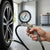 Car Tyre Pressure Gauge measuring tyre pressure on a car for safety and efficiency.