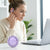 Woman using Wireless Ear-Clip Sports Earbuds while working on a laptop in a bright, modern setting.