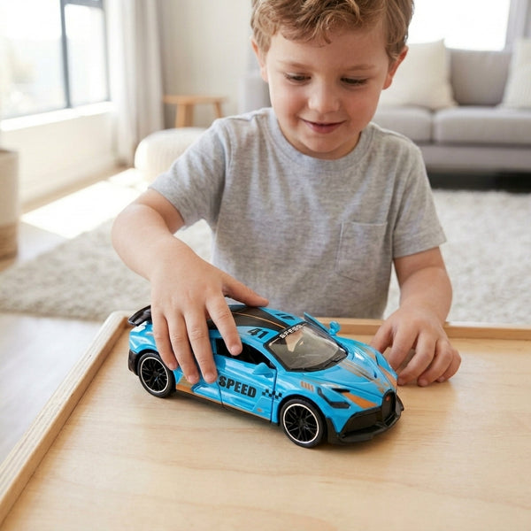 Child playing with a blue 1 32 Scale Diecast Pull Back Supercar on a wooden table.