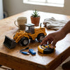 Kids Engineering Bulldozer Toy with Rolling Wheels on a table with remote control and accessories.