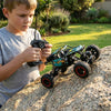 Off-Road RC Rock Crawler 4WD Large Scale Remote Control Truck being operated by a boy on a rocky terrain.