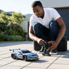 Person controlling a Scale RC Drift Car 4WD High Speed on a driveway.