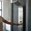 Person using the Stainless Steel Rainfall Waterfall Shower Panel in a modern bathroom.