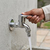 Hand turning on the Chrome Plated Brass Bib Tap with water flowing from the spout.