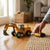 Alloy Friction Powered Engineering Excavator Toy with remote control on a wooden floor.