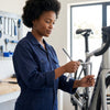 Woman using a Chrome Vanadium Y-Type Wrench Spanner Set to repair a bicycle in a workshop.