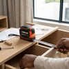 High Visibility Impact Resistant Tape Measure on a wooden drawer, measuring accurately for construction.