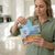 Woman using Multi-Effect Eco-Friendly Hard Floor Wipes in a modern kitchen for easy cleaning.