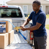 Man securing cargo with 1000kg Heavy Duty Ratchet Tie Down Strap in a truck bed.