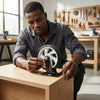 Man installing a Single Swivel Shopping Cart Caster Wheel on a wooden surface in a workshop.