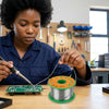 User soldering a circuit board with Tin Lead Rosin Core Solder Wire 100g Reel in a workshop environment.
