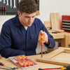 A person using the 5-Piece Insulated Magnetic Screwdriver Kit to work on a wooden project.