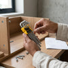 Person holding Carbon Steel L-Type Torx Hex Key Set while assembling furniture.