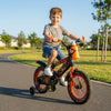 A happy child riding the Carbon Steel Kids Training Bike in a park, showcasing its vibrant design and stability.