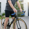 Person riding a Single Speed Aluminium Alloy Fixed Gear Bike with blue handlebars and cycling attire.