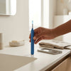 Ear Wax Removal Camera Kit with LED Light placed on a bathroom counter next to a smartphone.