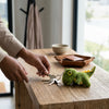 Cute Tyrannosaurus Rex Dinosaur Plush Backpack keychain on a wooden table, highlighting playful design and functionality.