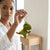 Cute Tyrannosaurus Rex Dinosaur Plush Backpack keychain held by a woman, showcasing the cute plush design.