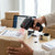 Person using NT-2012 1D USB Wired Laser Barcode Scanner on a shipping label at a desk.