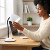 Person adjusting the Flexible Gooseneck Desktop Table Lamp on a wooden desk with a laptop and notebook.