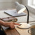 Flexible Gooseneck Desktop Table Lamp providing adjustable lighting on a workspace with a cup of coffee.