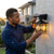 Outdoor Solar Lamp Waterproof Human Induction Light being installed by a man outdoors, showcasing its practical design and functionality.