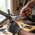 Person using a 9.5 mm Drive Ratchet Handle to tighten a metal frame in a workshop setting.