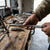 Person using a 15 Inch L-Handle Socket Wrench on a workbench with tools in a workshop.