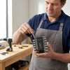 Man using a 14 Piece Power Nut Driver Set, demonstrating its features in a workshop setting.