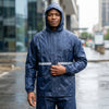 Man wearing waterproof jacket made from 210T Waterproof PU Coated Polyester Taffeta Fabric in the rain.