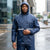 Man wearing waterproof jacket made from 210T Waterproof PU Coated Polyester Taffeta Fabric in the rain.