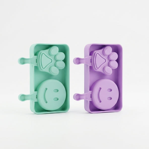 Silicone Paw and Smiley Face Ice Cream Moulds in pastel colors for creating fun frozen treats.