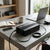 High-End Pure Sine Wave Power Inverter on a table with laptop, notebook, and coffee cup in a modern workspace.