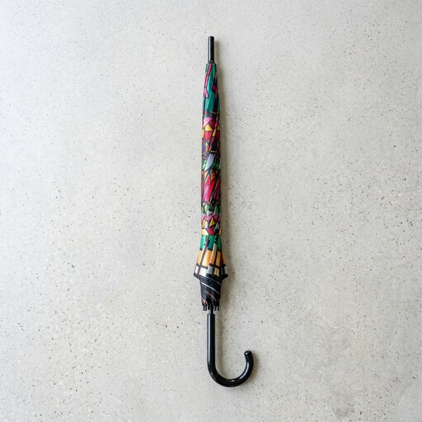 Colorful Patterned Long Handle Umbrella closed and ready for use, showcasing vibrant patterns on the canopy.