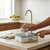 Rechargeable Desktop Water Dispenser Pump filling a glass with water in a kitchen setting.