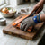 Level 9 Stainless Steel Mesh Cut Resistant Glove protecting hands while cutting salmon on a wooden board.