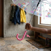 A person holding a Reinforced Transparent Windproof Long Handle Umbrella with a unicorn design.