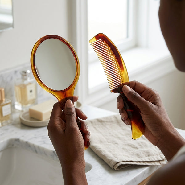 Classic Mirror and Comb Grooming Set featuring a tortoiseshell handheld mirror and comb on a bathroom counter.