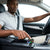 Bluetooth Car MP3 Player FM Transmitter being used in vehicle, with a driver adjusting settings on the device.