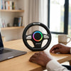 Steering Wheel Bluetooth Speaker placed on a table next to a laptop and coffee cup, showcasing hands-free audio functionality.