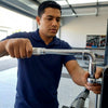 Person using Pipe Socket Wrench L-Shaped to tighten fasteners in a garage setting.