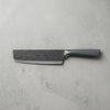 Velvet-Touch Pastel Precision Knife on a textured gray surface, showcasing its sleek design and fine cutting edge.