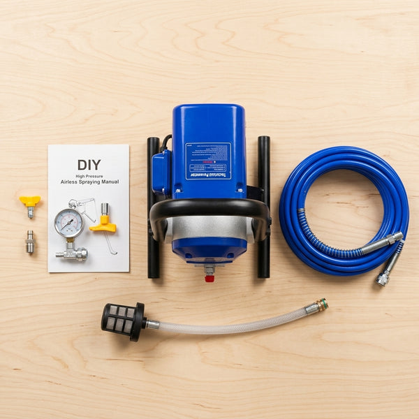 Airless Paint Sprayer with blue motor, hose, manual, and spray components on wooden surface.