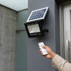 IP65 Waterproof LED Floodlight with remote control mounted on a wall, showcasing modern outdoor lighting technology.