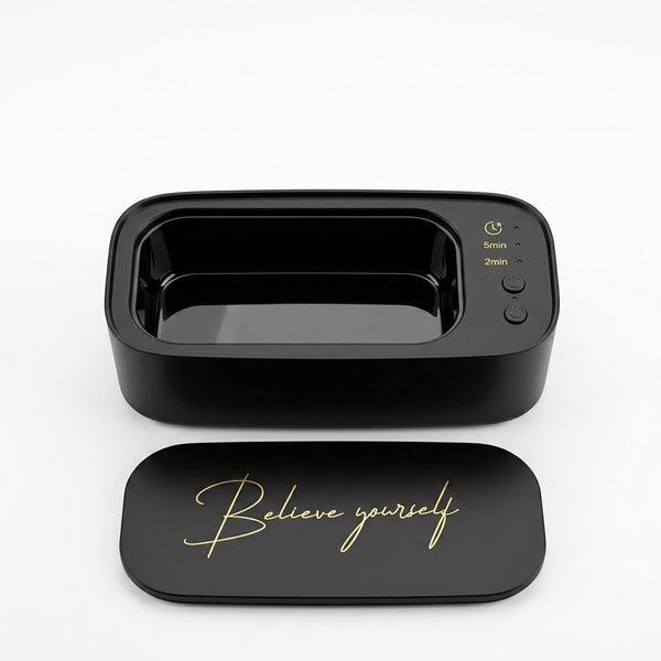 Professional Ultrasonic Mini Jewelry Cleaner in sleek black design with button controls and motivational lid.