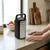 Portable LED Emergency Light Rechargeable Lantern on a kitchen countertop with hands nearby.