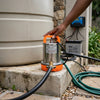 Brushless Solar Water Pump placed next to a water tank, used for efficient water transfer with solar energy.