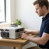 Man using a 4000W Switching Power Supply AC DC Unit on a desk in a well-lit room.