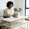 Woman sitting at a Nail Bar Station Salon Desk, enjoying a cup of coffee in a modern living room.