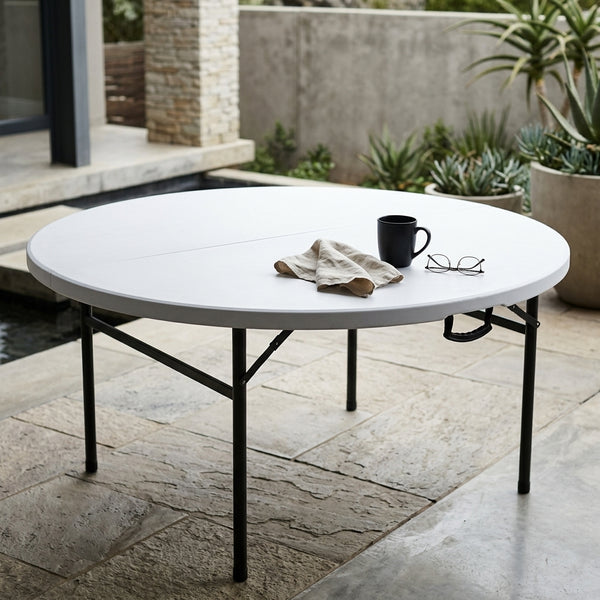 Fold-in-Half Round Catering Table with coffee mug and napkin on a patio setting.